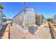 Well-maintained manufactured home with a modern air conditioning unit, set amidst a desert landscape with easy-care gravel at 111 S Greenfield Rd # 405, Mesa, AZ 85206
