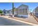 This manufactured home features a desert landscape with a towering Saguaro cactus, offering a serene desert experience at 111 S Greenfield Rd # 405, Mesa, AZ 85206