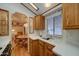 The kitchen features white countertops, wood cabinets, and a sink by a window at 111 S Greenfield Rd # 405, Mesa, AZ 85206