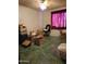 Bright bedroom with red curtains and green flooring, with moving boxes and furniture at 1116 E Almeria Rd, Phoenix, AZ 85006