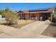 Ranch-style home with a red roof, solar panels, a covered parking area, and a chain link fence at 1116 E Almeria Rd, Phoenix, AZ 85006