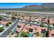 Scenic aerial view of a neighborhood with well-maintained homes, pools, and mountain views in the background at 11217 E Laurel Ln, Scottsdale, AZ 85259