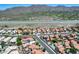 An aerial view of a community with red-tiled roofs with desert landscaping and a waterway in the background at 11217 E Laurel Ln, Scottsdale, AZ 85259