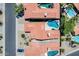 An aerial view showing houses with red tile roofs, backyards with pools, and tree-lined streets at 11217 E Laurel Ln, Scottsdale, AZ 85259