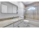 Traditional bathroom showcasing white vanity with granite countertop and a shower over bath at 11217 E Laurel Ln, Scottsdale, AZ 85259