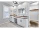Well-lit bathroom featuring dual sinks with granite countertops, tile flooring and a closet at 11217 E Laurel Ln, Scottsdale, AZ 85259