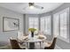 This cozy breakfast nook features plantation shutters and a modern ceiling fan for a delightful start to your day at 11217 E Laurel Ln, Scottsdale, AZ 85259