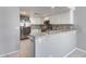 Spacious kitchen area features stainless steel appliances, granite countertops, and a convenient breakfast bar at 11217 E Laurel Ln, Scottsdale, AZ 85259