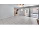 Open living area with tile flooring, sliding glass doors to the backyard, and easy access to the staircase at 11217 E Laurel Ln, Scottsdale, AZ 85259