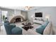 Cozy living room featuring a unique brick fireplace, plush seating, and ample natural light, perfect for relaxation at 11217 E Laurel Ln, Scottsdale, AZ 85259