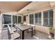 Covered outdoor dining area with stylish furniture, modern lighting, and views of the backyard and privacy screen at 11217 E Laurel Ln, Scottsdale, AZ 85259