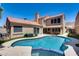 Backyard oasis features a sparkling pool with blue tile accents and a covered patio for relaxing in the shade at 11217 E Laurel Ln, Scottsdale, AZ 85259