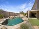Private backyard featuring a pebble tec pool, desert landscaping, and privacy fence at 11534 E Downing St, Mesa, AZ 85207