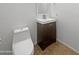 Bathroom featuring a modern sink with dark wood cabinet and a toilet with a closed tank at 11534 E Downing St, Mesa, AZ 85207