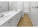 Bright bathroom with dual sinks, tile flooring, and a view into the shower room at 11534 E Downing St, Mesa, AZ 85207