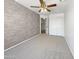 Spacious bedroom with a ceiling fan, textured wall, and carpet flooring at 11534 E Downing St, Mesa, AZ 85207
