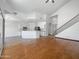 Open floor plan with hardwood floors leading to a kitchen with white cabinets at 11534 E Downing St, Mesa, AZ 85207