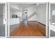 Spacious living room with hardwood floors, white cabinets, and a large glass sliding door at 11534 E Downing St, Mesa, AZ 85207