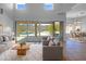 Bright living room with soaring ceilings, modern furnishings, and a view of the backyard pool at 11534 E Downing St, Mesa, AZ 85207