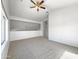 Spacious loft area with large windows, neutral carpet, and a light-filled atmosphere at 11534 E Downing St, Mesa, AZ 85207
