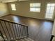 Upstairs living area with modern flooring, natural light, and exterior door at 1212 W Glenmere Dr, Chandler, AZ 85224
