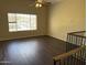 Bright living space with modern flooring, large window, and ceiling fan at 1212 W Glenmere Dr, Chandler, AZ 85224