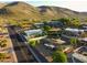 Aerial view of a neighborhood with desert landscaping, homes, street and mountains in the background at 13034 N 8Th Ave, Phoenix, AZ 85029