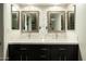 Modern bathroom featuring double sinks, framed mirrors, and decorative tile backsplash at 13034 N 8Th Ave, Phoenix, AZ 85029
