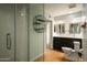 Bathroom with glass shower, double sink vanity with modern fixtures, and open shelving at 13034 N 8Th Ave, Phoenix, AZ 85029