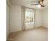 Bright bedroom with neutral carpet, large window with curtain, and ceiling fan with light at 13034 N 8Th Ave, Phoenix, AZ 85029