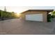 Spacious garage with long driveway and desert landscaping with bright sunlight at 13034 N 8Th Ave, Phoenix, AZ 85029