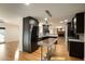 Open kitchen featuring stainless steel appliances, an island, and dark wood cabinets at 13034 N 8Th Ave, Phoenix, AZ 85029