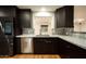 Updated kitchen with stainless steel appliances, light countertops, and dark wood cabinets at 13034 N 8Th Ave, Phoenix, AZ 85029