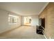 Spacious living room with neutral carpet and decorative wallpaper accent wall at 13034 N 8Th Ave, Phoenix, AZ 85029