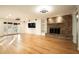Large living room features a brick fireplace, wood floors, and recessed lighting at 13034 N 8Th Ave, Phoenix, AZ 85029