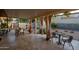 Outdoor patio with a fireplace, dining area, shed, gravel, and landscaping at 13034 N 8Th Ave, Phoenix, AZ 85029