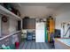 The inside of the shed featuring shelving, countertop and large fridge at 13034 N 8Th Ave, Phoenix, AZ 85029