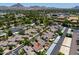 An aerial view of a peaceful residential neighborhood surrounded by lush trees and a mountain backdrop at 1417 E Marshall Ave, Phoenix, AZ 85014