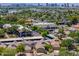 Scenic aerial view of a neighborhood with mature trees and city skyline, offering a blend of suburban and urban living at 1417 E Marshall Ave, Phoenix, AZ 85014