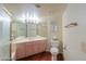 Spacious bathroom with a large mirror, modern fixtures, and laminate floors at 1417 E Marshall Ave, Phoenix, AZ 85014
