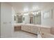 Spacious bathroom featuring double sinks, a soaking tub, a separate shower, and ample counter space at 1417 E Marshall Ave, Phoenix, AZ 85014