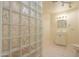Bright bathroom featuring a glass block wall accent and updated vanity at 1417 E Marshall Ave, Phoenix, AZ 85014