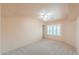 Spacious bedroom featuring soft carpet, ceiling fan, and window with shutters at 1417 E Marshall Ave, Phoenix, AZ 85014