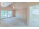 Bright bedroom with vaulted ceilings, neutral carpet, built-in shelving, and sliding doors to the backyard at 1417 E Marshall Ave, Phoenix, AZ 85014