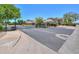 Gated community entrance showcasing well-maintained landscaping and multiple residential homes under a clear sky at 1417 E Marshall Ave, Phoenix, AZ 85014