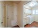 Hallway view to the laundry room with a washer and dryer at 1417 E Marshall Ave, Phoenix, AZ 85014