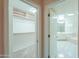 Hallway view of the walk-in closet with built-in shelving and the Primary bathroom at 1417 E Marshall Ave, Phoenix, AZ 85014