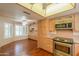 This kitchen boasts stainless steel appliances, light wood cabinets, and hardwood floors at 1417 E Marshall Ave, Phoenix, AZ 85014