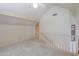 Second floor landing with neutral carpet and white railings at 1417 E Marshall Ave, Phoenix, AZ 85014