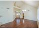 Expansive living room with hardwood floors, high ceilings, a statement chandelier, and a staircase at 1417 E Marshall Ave, Phoenix, AZ 85014